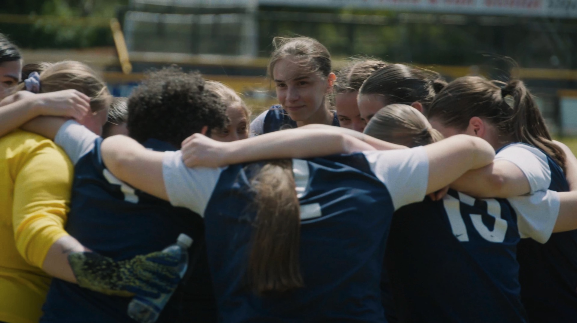 Emily's Last Game - Emily in a team huddle before kick-off