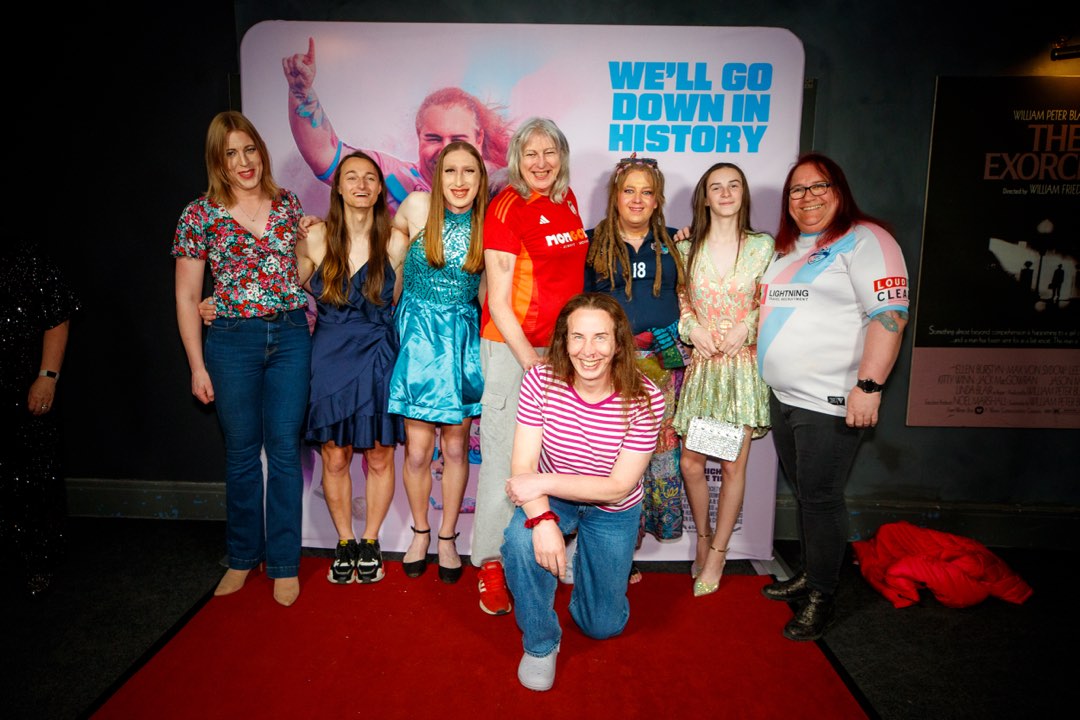 Group in football shirts at a red-carpet gala screening