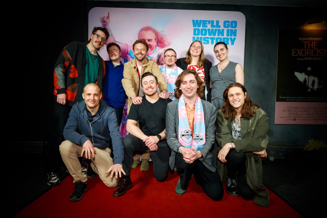 Group posing on the red carpet at a gala screening
