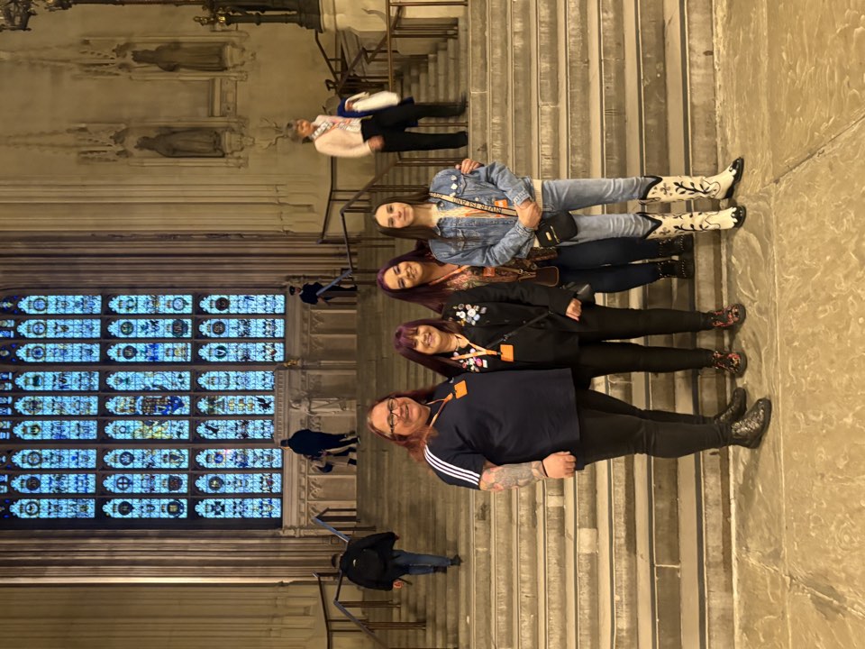 Group on stone steps at an evening event