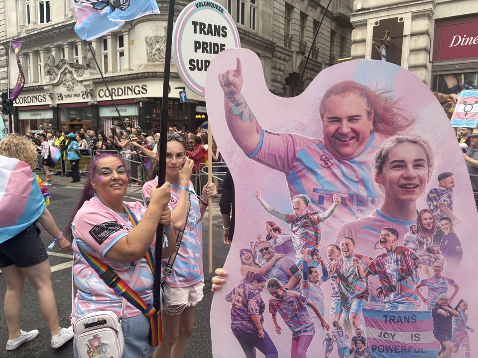 Group with a film poster cutout at a parade