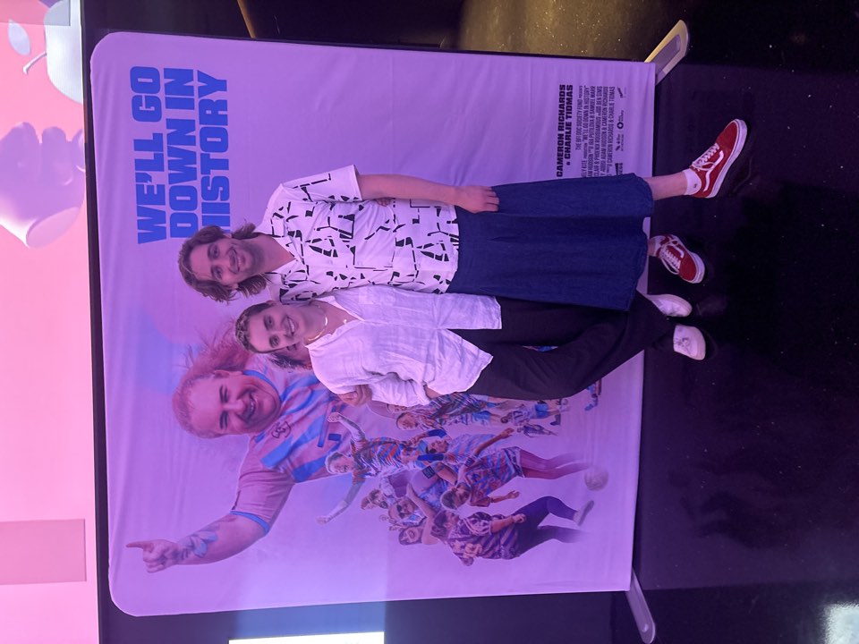 Guest beside the film's poster display